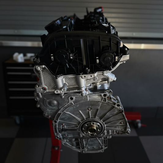 CarBahn San Jose technician installing a high-performance heat exchanger on a BMW S58 engine.
