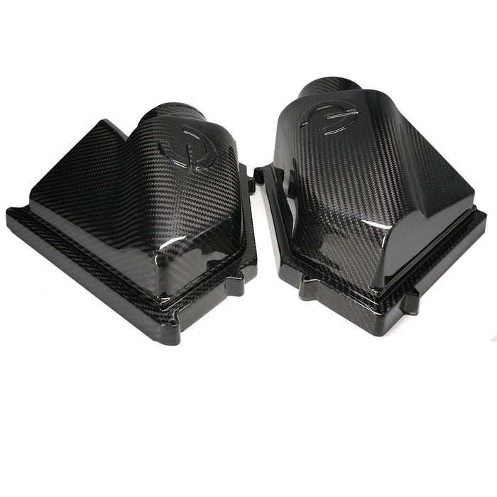 Two carbon fiber foot pegs on a white background