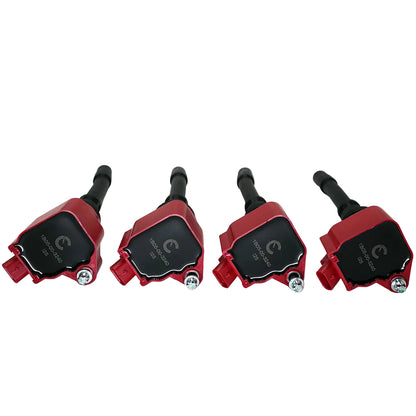 Four red and black ignition coils on a white background